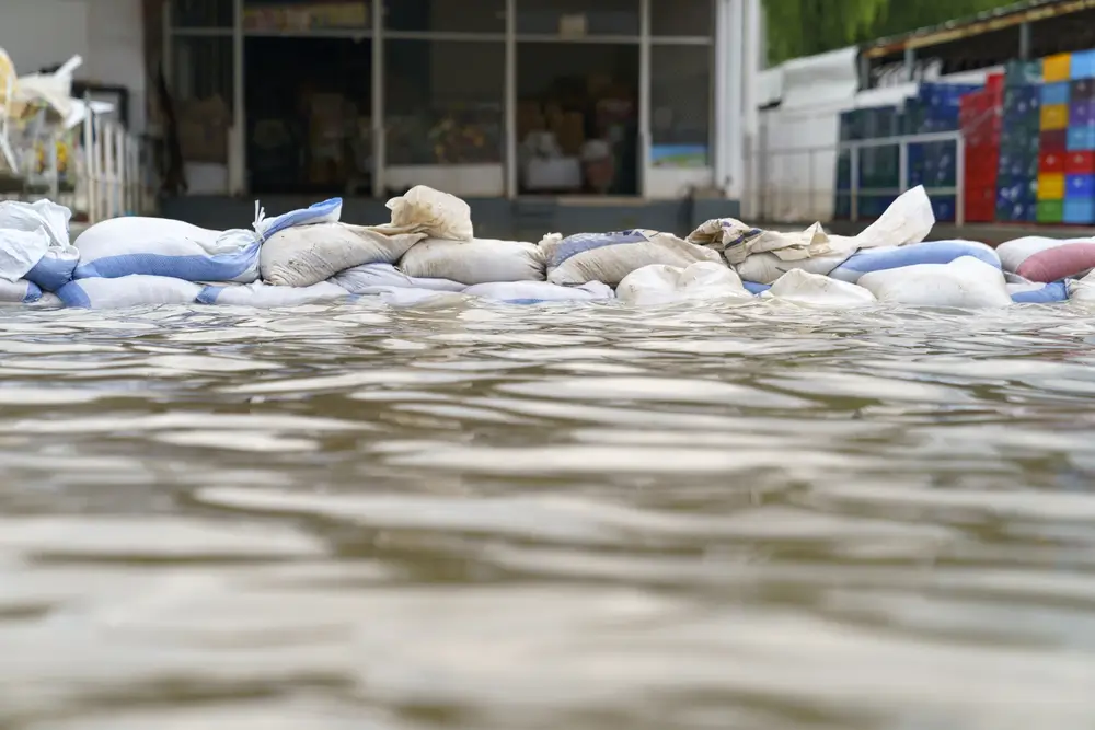 Sandbags stacked in front of a store to prevent water damage from flooding